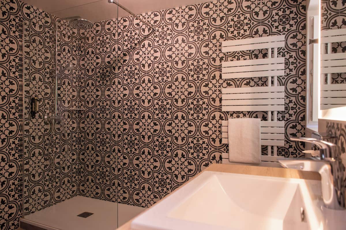 standard double room | bathroom | rainfall showerhead, eco-friendly toiletries, hair dryer, bathrobes