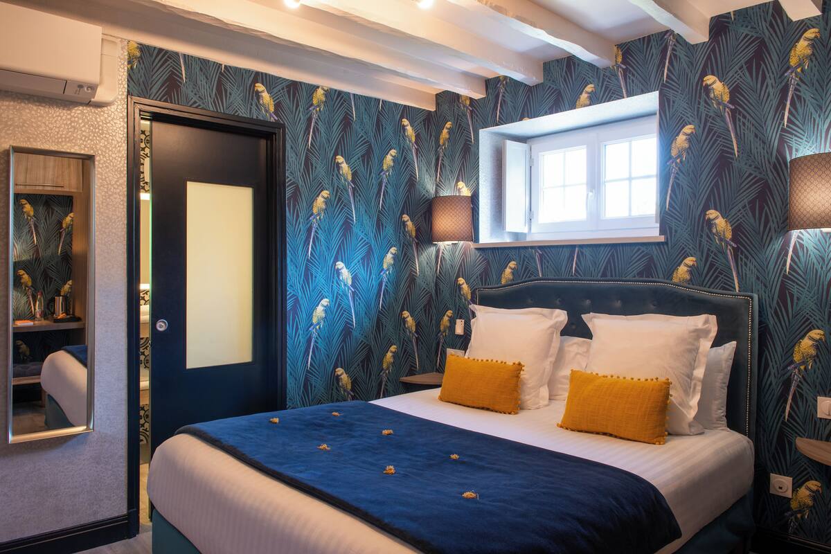 A bedroom with a bed, a window, and a door.
