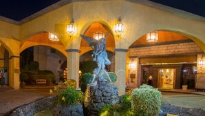 A building with a stone facade, arched entrances, and a central fountain statue. - Holiday Inn Queretaro-Centro Historico by IHG (Querétaro)