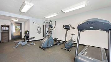 A gym with treadmills, elliptical machines, and weight equipment.