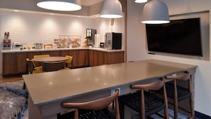 A modern hotel room with a large bed, a bedside table, and a nightstand. There is a window with a view of the city skyline. - Fairfield Inn & Suites by Marriott Arlington Six Flags (Arlington)
