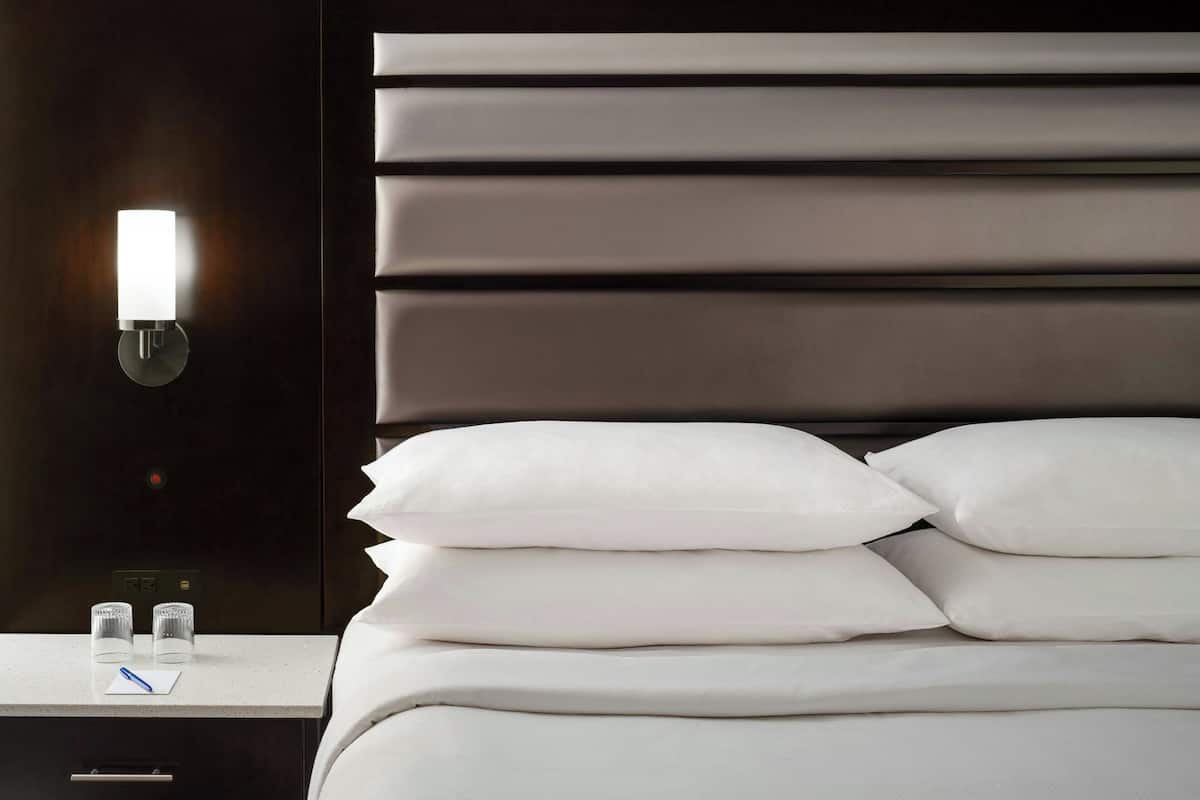 Premium bedding, desk, laptop workspace, blackout curtains