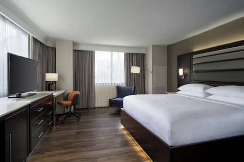 Premium bedding, desk, laptop workspace, blackout drapes
