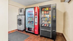 A vending area with a Coca-Cola cooler, a red Coca-Cola machine, and a push vending machine. - Red Roof Inn Jackson Downtown - Fairgrounds (Jackson)