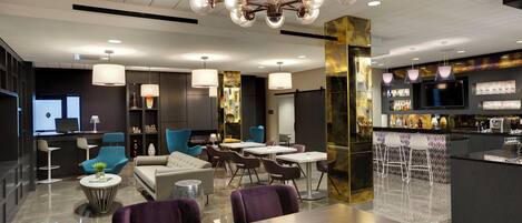 A modern interior with a dining area, bar, and seating.