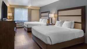 A hotel room with two beds, a TV, a desk, and a window with curtains. - Best Western Sunridge Inn & Conference Center (Baker City)