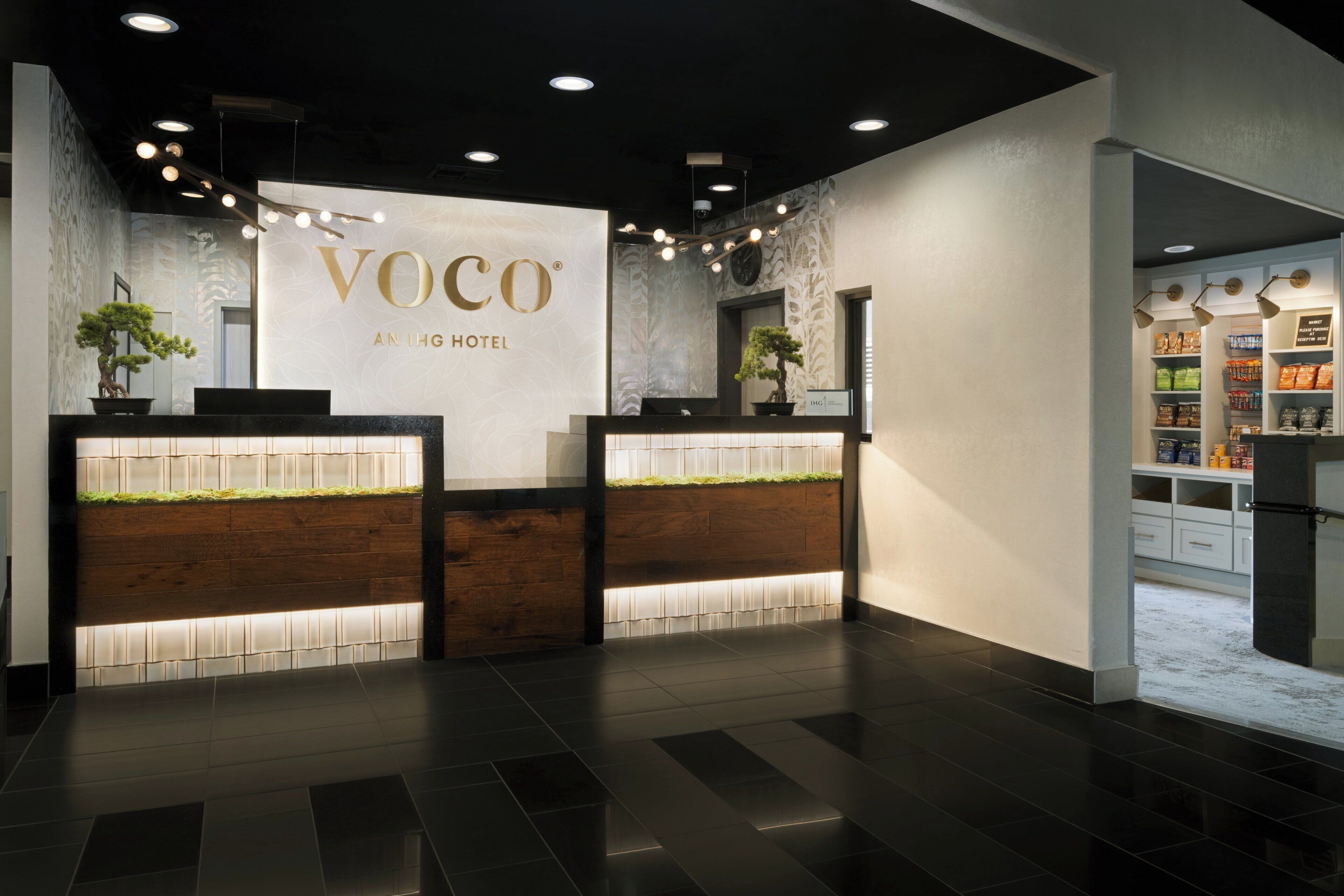 A reception area with a reception desk, a wall-mounted clock, and a sign indicating a market area.