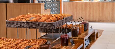 A bakery display with pastries and jams.