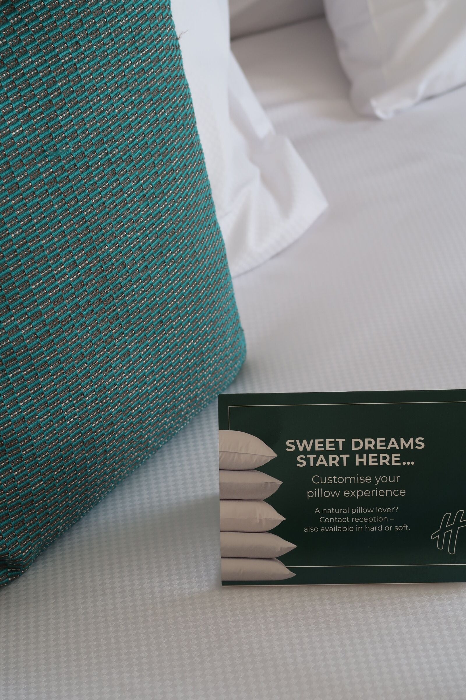 A pillow with a textured pattern and a box with text about a pillow customization service.