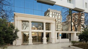 A modern building with a glass facade, a sign reading 'Alfonso's,' and a visible entrance.