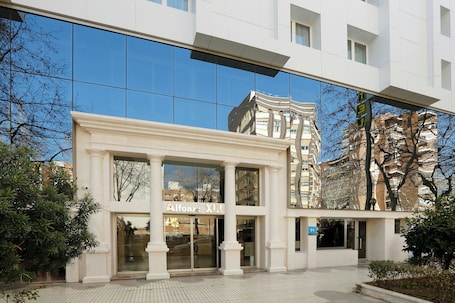 A modern building with a glass facade, a sign reading 'Alfonso's,' and a visible entrance.. Hotel Sercotel Alfonso XIII