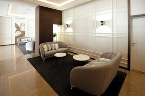 A modern lobby with a sofa set, round tables, and a decorative wall. - Hotel Sercotel Alfonso XIII (Cartagena)