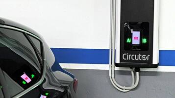 A parking garage with a car and a charging station labeled 'Circulator'.