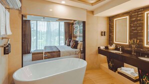 A modern bathroom with a freestanding bathtub, a large mirror, and a vanity with a sink. - Sarova Panafric Hotel, Nairobi Upper Hill (Nairobi)