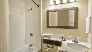 A bathroom with a bathtub, a sink, a toilet, and a shower.