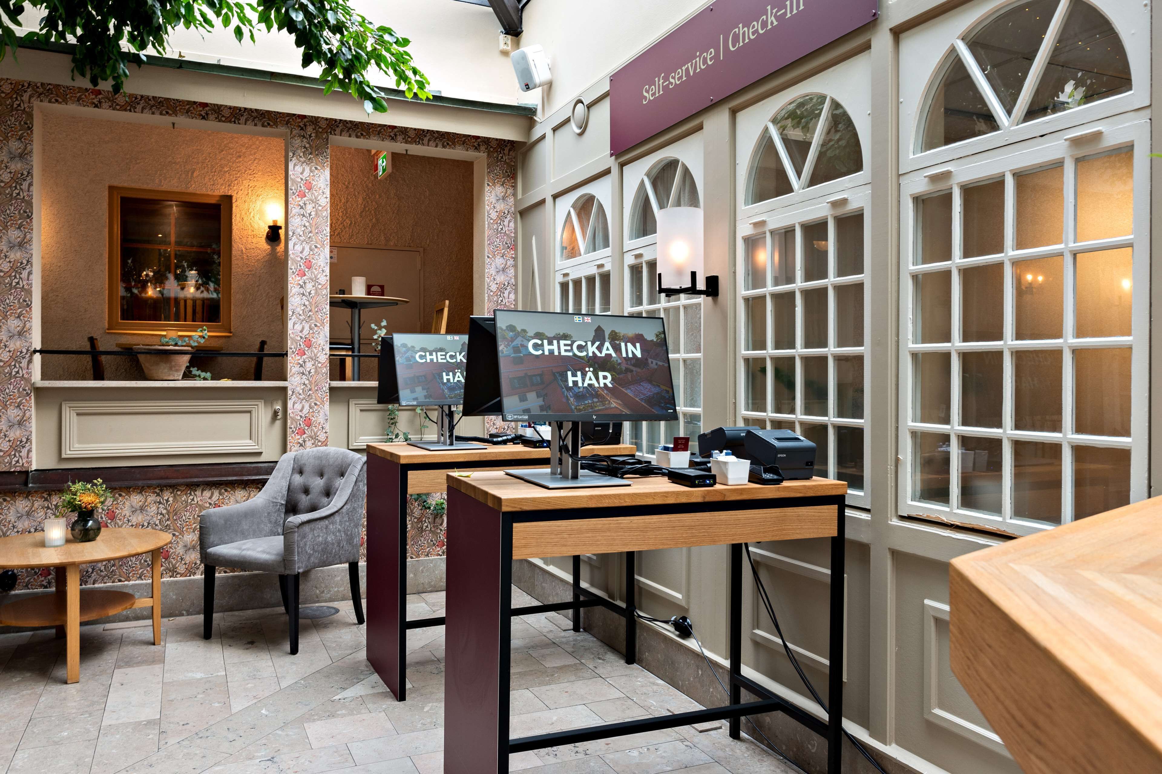 A self-service check-in area with computers and seating.