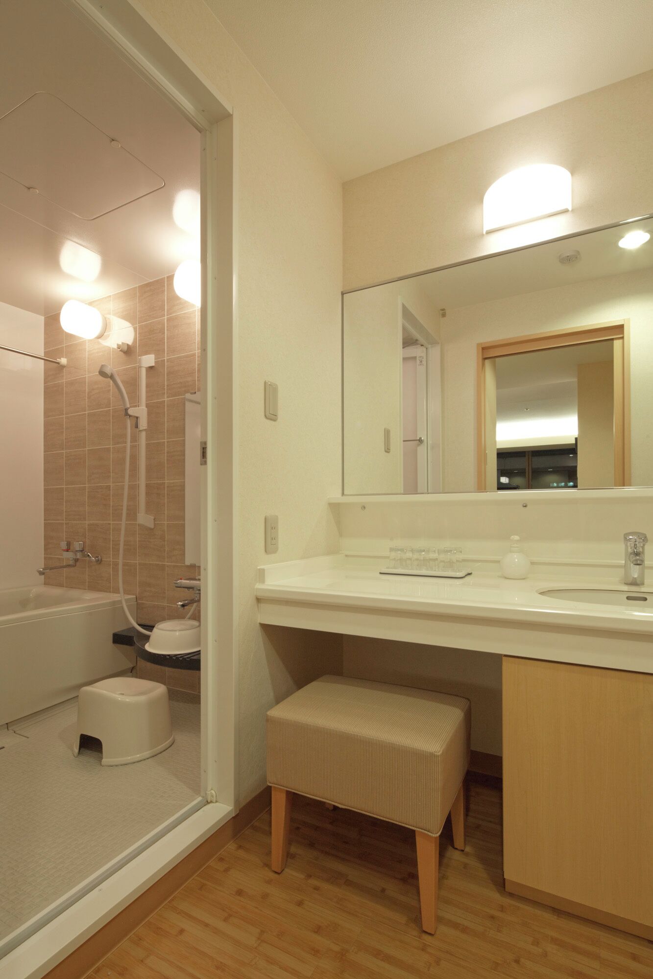 A modern bathroom with a shower, toilet, and sink.
