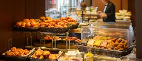 Un bufé con diversas opciones de panadería y pastelería.