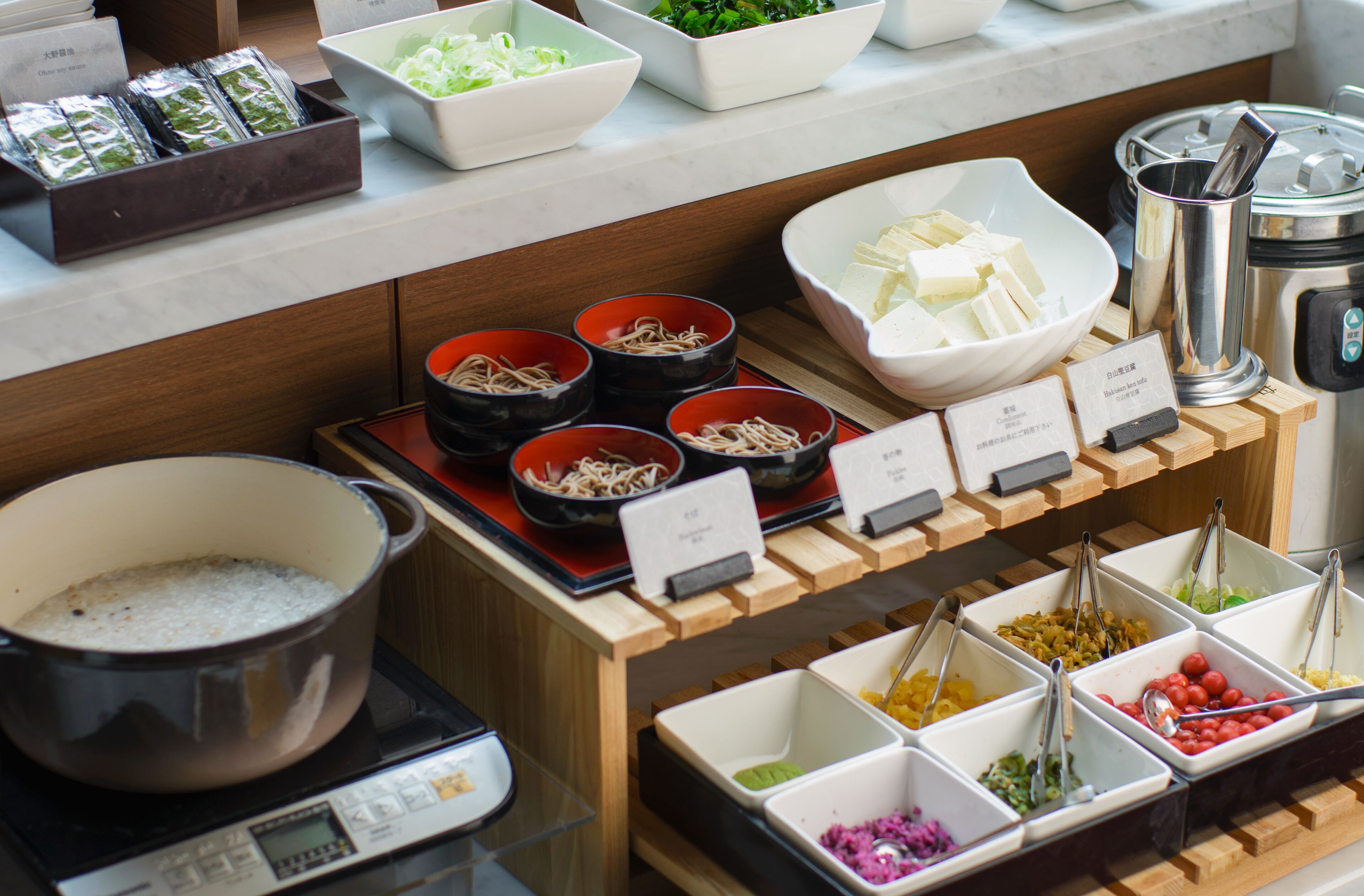 A buffet with various food items and containers.