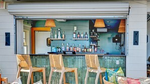 An outdoor bar area with wooden chairs and a bar counter. - The Partridge Inn Augusta, Curio Collection by Hilton (Augusta)