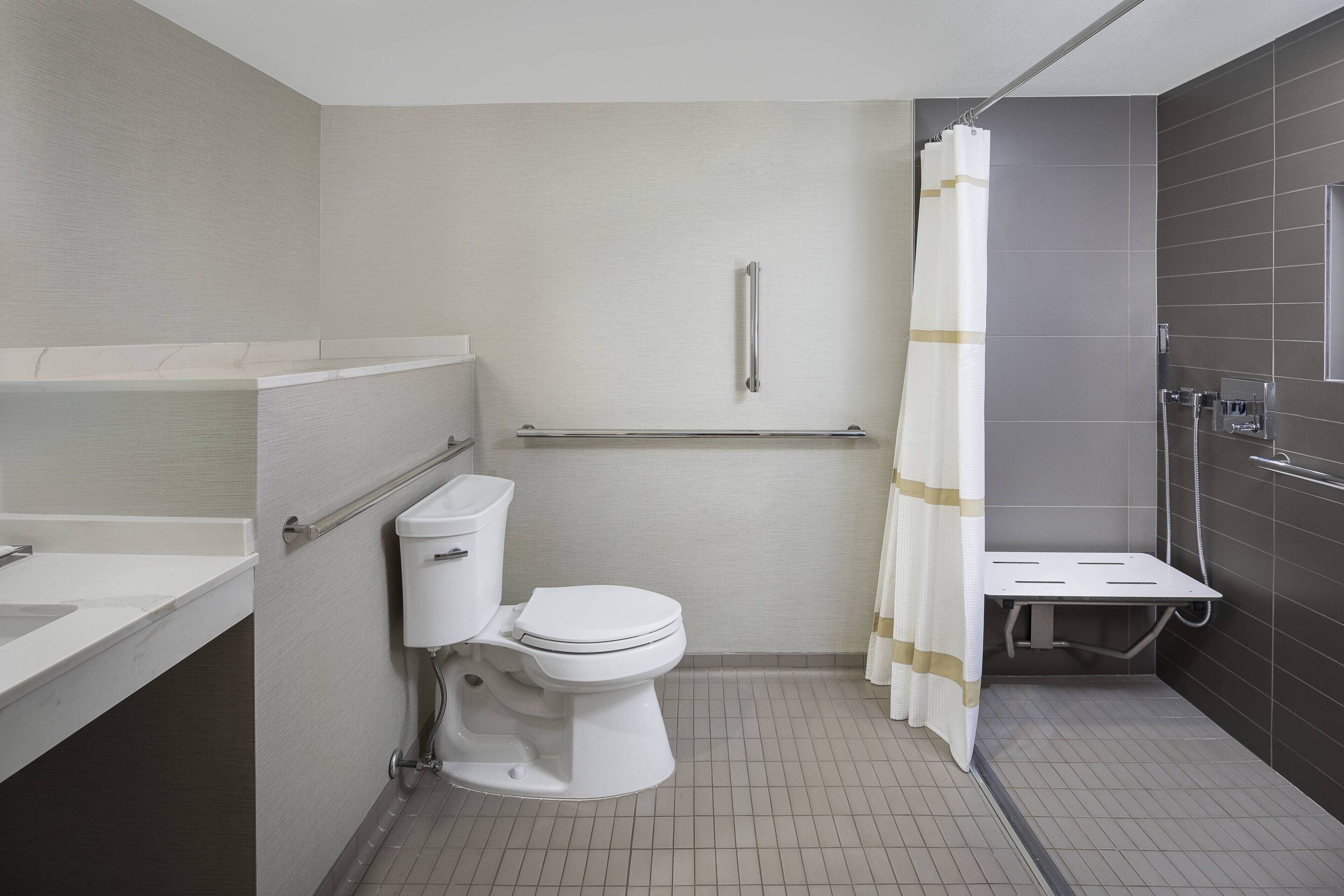 combined shower/bathtub, designer toiletries, hair dryer, bathrobes