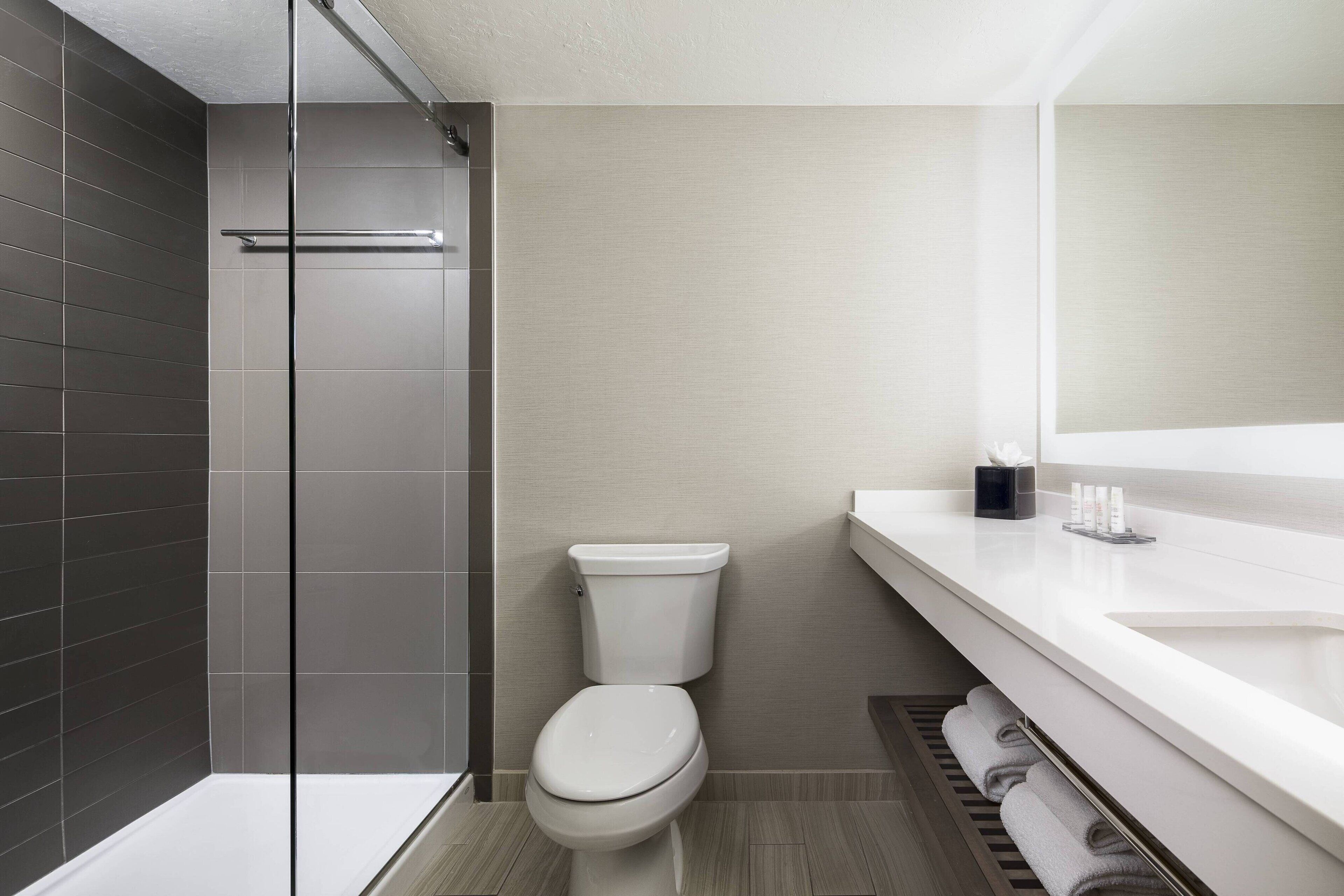 combined shower/bathtub, designer toiletries, hair dryer, bathrobes