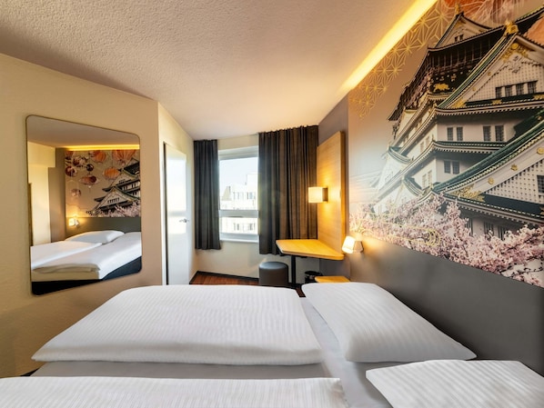 A hotel room with two beds, a large mirror, a wall-mounted TV, and a window with curtains. - B&B Hotel Düsseldorf-Hbf (Düsseldorf)