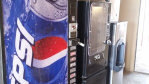 A vending machine area with a Pepsi advertisement, a refrigerator, and a water dispenser. - Super 8 by Wyndham Waco/Mall area TX (Waco)