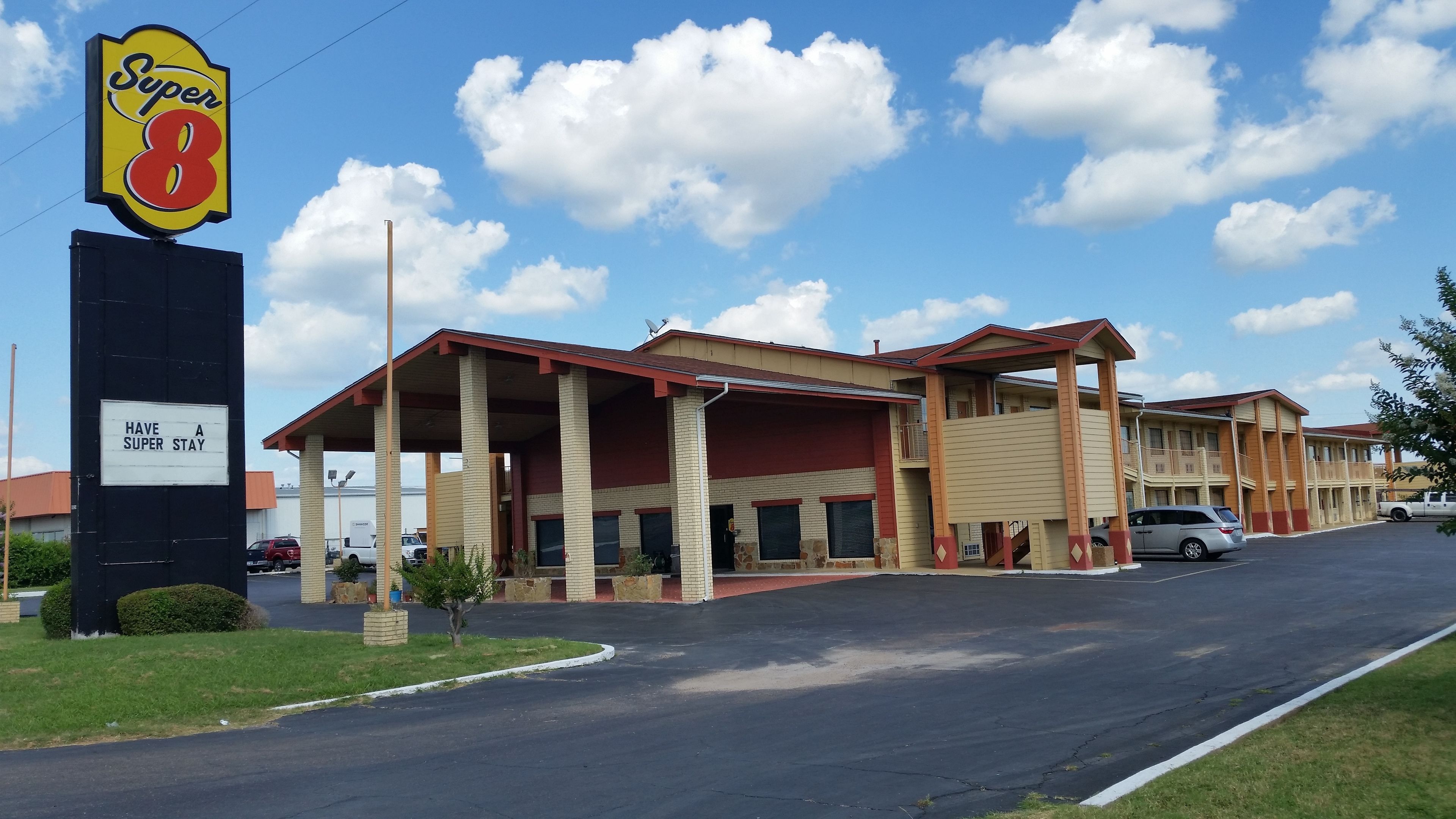 A motel with a large sign reading "Super 8" and a sign below stating "Have a Super Stay".