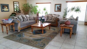 A living room with two sofas, a coffee table, and a patterned rug. - Super 8 by Wyndham Waco/Mall area TX (Waco)