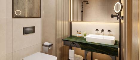 A modern bathroom with a toilet, sink, and shower.