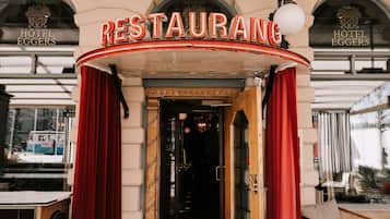 The entrance to a restaurant with a sign that reads "RESTAURANT" and "HOTEL EGGERS" above it.