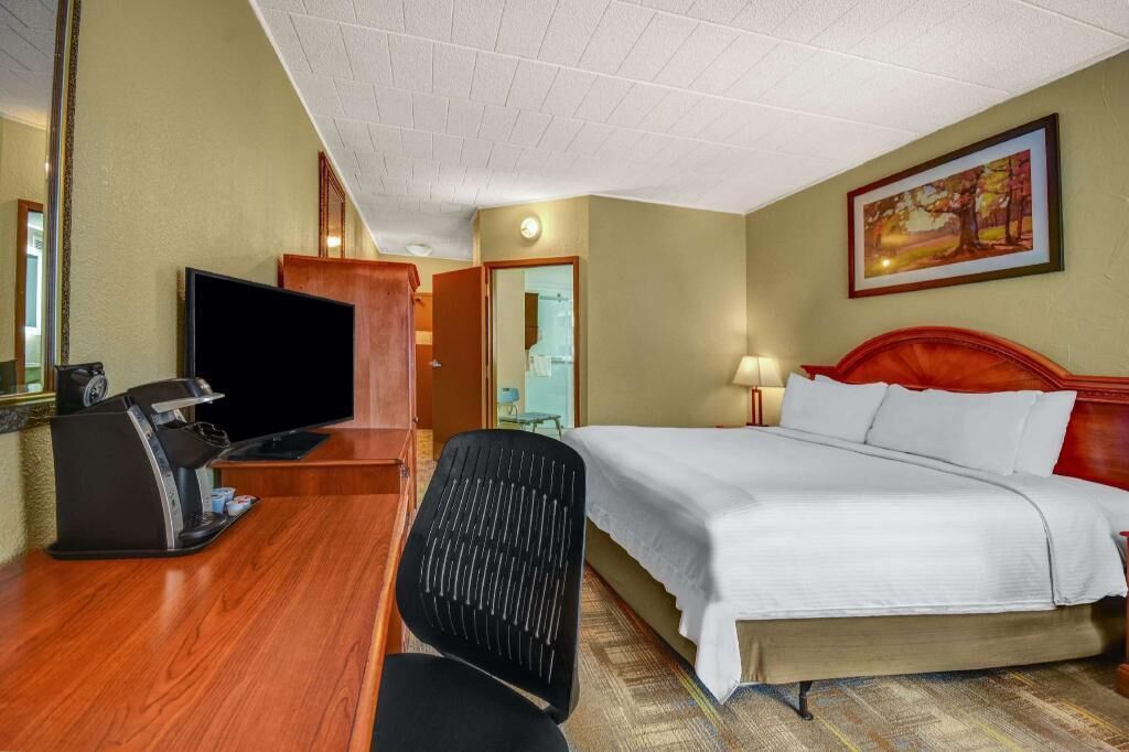 Premium bedding, desk, laptop workspace, iron/ironing board