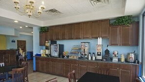 A restaurant with wooden cabinets, a black table, and chairs.