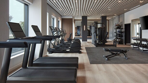 A modern gym with treadmills, elliptical machines, and free weights. - Delta Hotels by Marriott Toronto Markham (Markham)