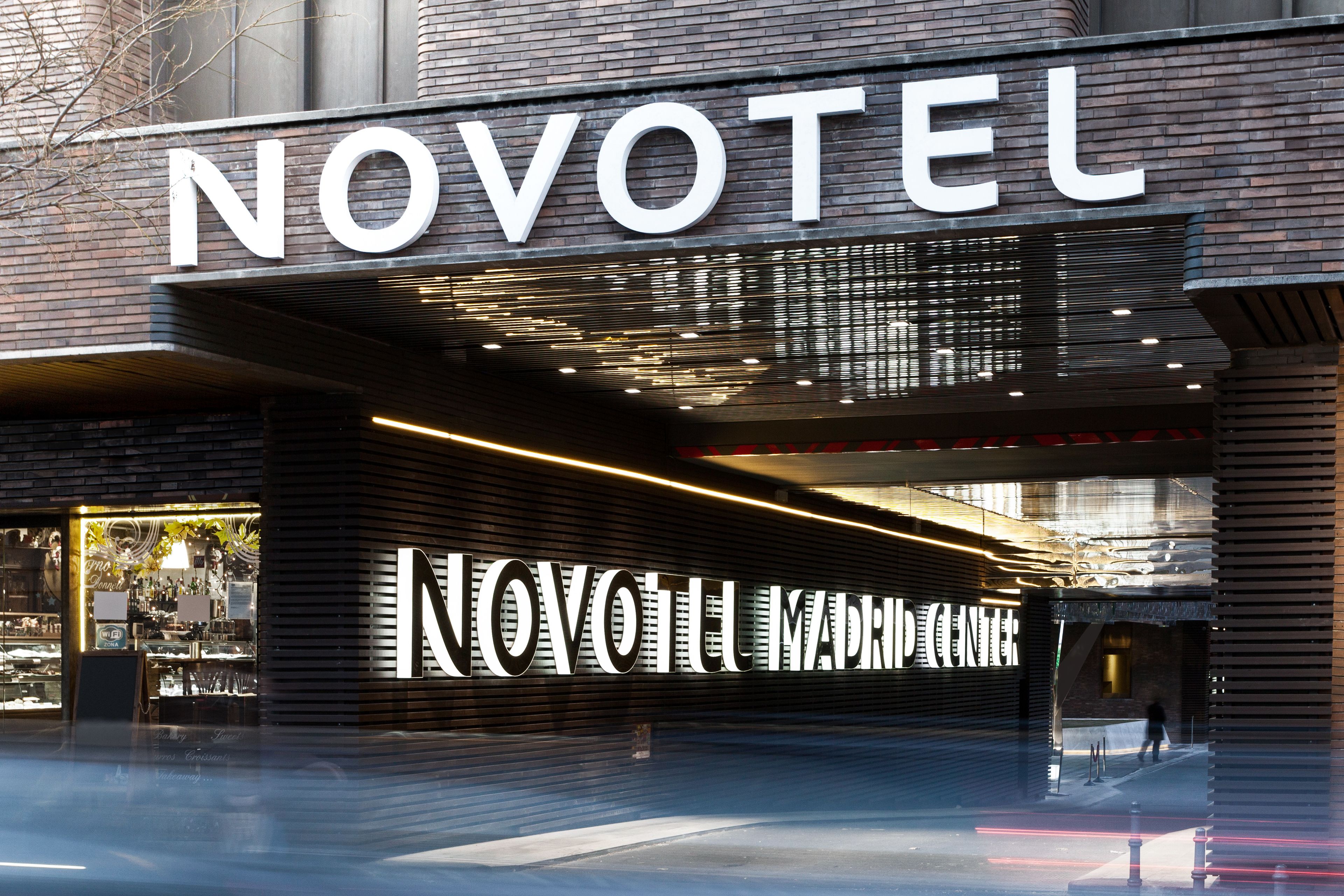 A hotel entrance with a prominent "NOVOTEL" sign.