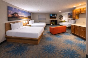 A hotel room with two beds, a sofa, a TV, and a painting on the wall. - Days Inn by Wyndham Sturgis (Sturgis)