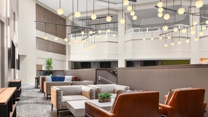 A spacious lobby with high ceilings, modern lighting, and comfortable seating areas. - Sheraton Suites Galleria-Atlanta (Atlanta)