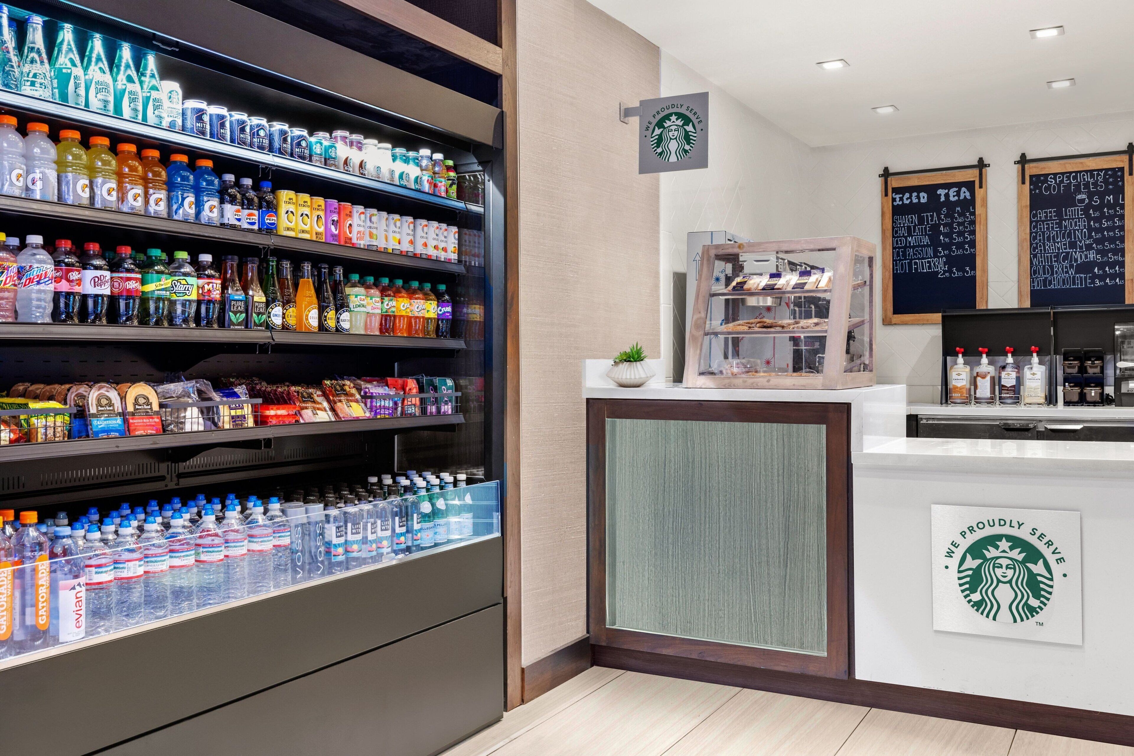 A beverage section with various drinks and a Starbucks counter with menu boards.