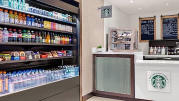 A beverage section with various drinks and a Starbucks counter with menu boards.