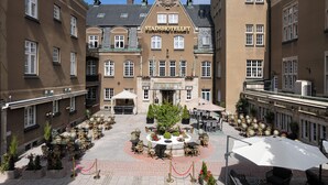 A Stadshotel with a central courtyard, outdoor seating, and a traditional European architectural style. - Elite Stadshotellet Västerås (Vasteras)