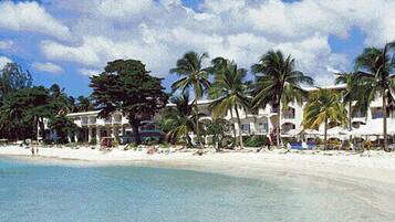On the beach, white sand, sun-loungers, beach towels