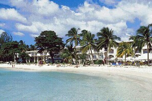 On the beach, white sand, sun loungers, beach towels