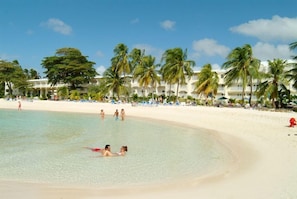 On the beach, white sand, sun loungers, beach towels