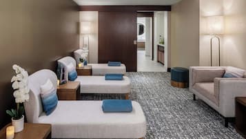 Relax in a spacious room with a large bed, seating area, and potted plant.