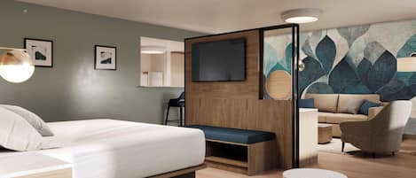 Habitación de hotel moderna con cama, zona de estar y televisor.