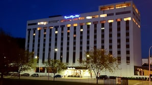 A multi-story hotel with a prominent sign at the top reading "Capital Plaza Hotel."