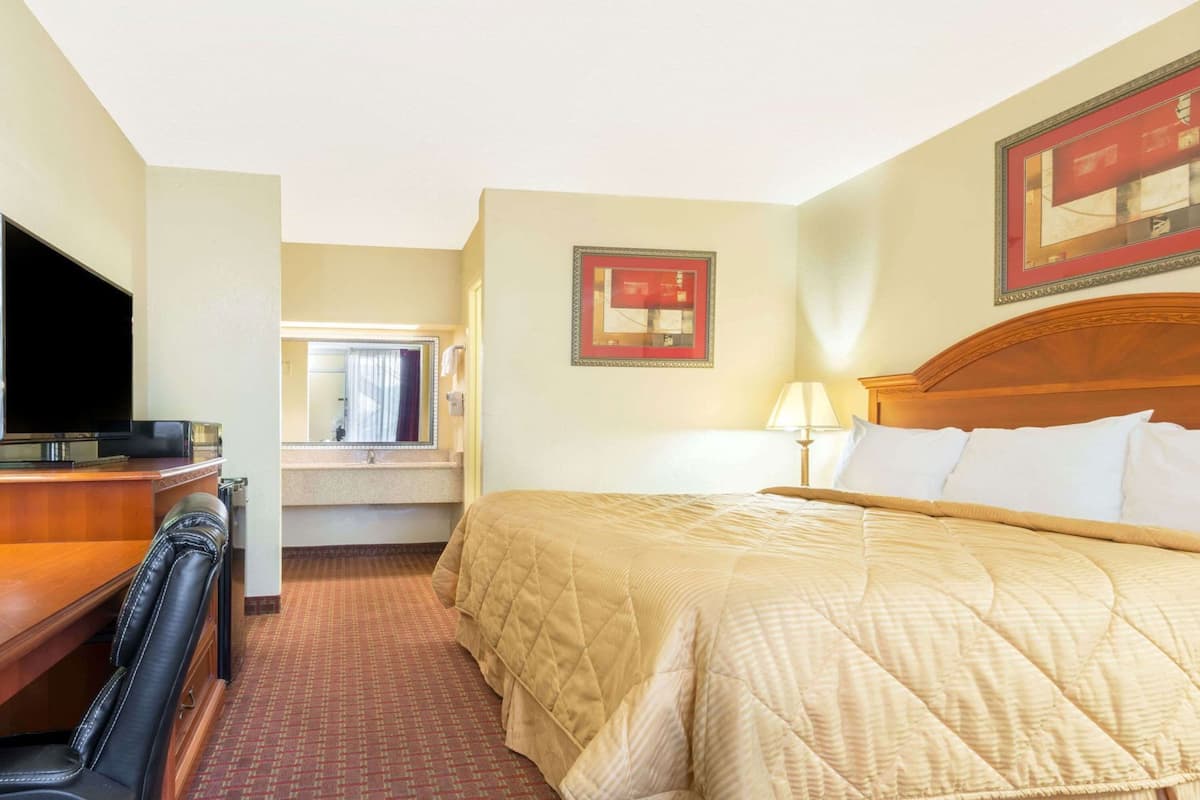 Premium bedding, desk, laptop workspace, iron/ironing board