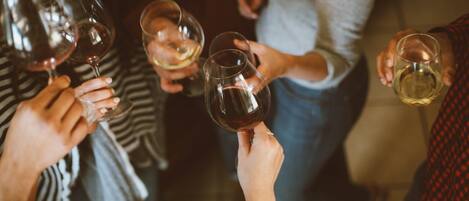 A group of people holding wine glasses, suggesting a social gathering.
