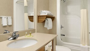 A bathroom with a sink, mirror, and bathtub. - Days Inn by Wyndham Rapid City (Rapid City)